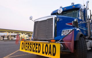 A truck with bump sign "Oversized Load"