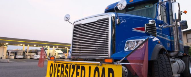 A truck with bump sign "Oversized Load"